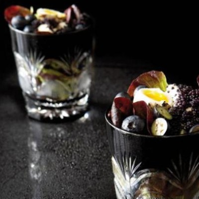 Blueberry salad with quail eggs and caviar