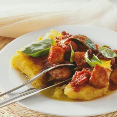 Grilled polenta with calamari in thick tomato wine sauce