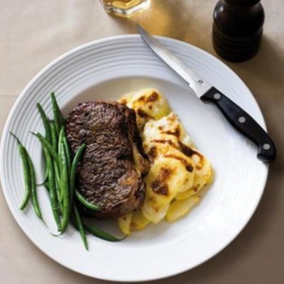 Matured sirloin steaks with cracked black pepper and buttery beans