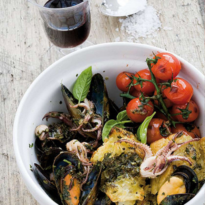 Mussels and squid in fresh-basil pesto with burst vine tomatoes