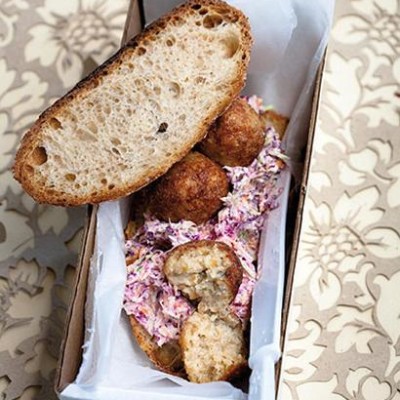 Open chicken croquette and coleslaw sandwich