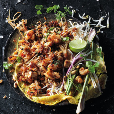 Pad Thai garnished with lemongrass, lime, coriander and spring onions