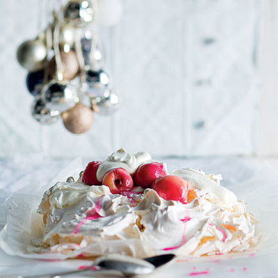 Pavlova with poached rosy white peaches and lemon cream