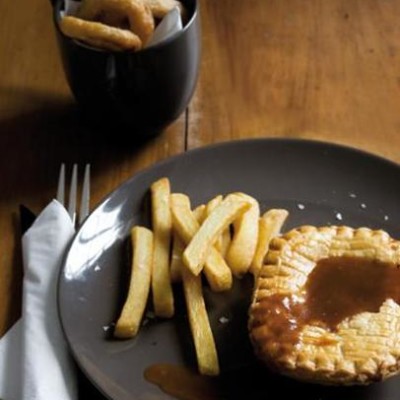 Pie and chips with traditional gravy and crispy onion rings