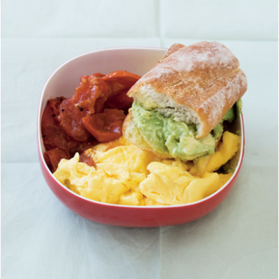 Scrambled egg and roasted tomato with crispy, smashed avocado-stuffed baguettes