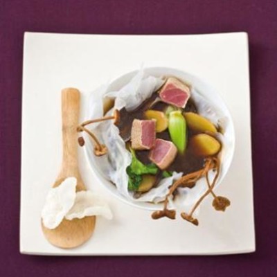 Seared tuna, ginger and dried mushroom broth in a starch sheet bowl