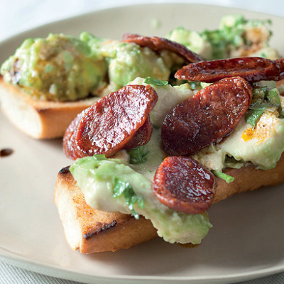 Smashed avocado and chorizo-topped French loaf