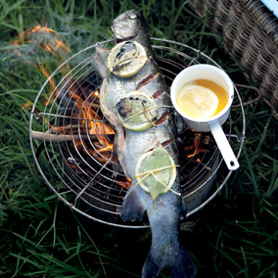 Whole chargrilled salmon trout with lemon-infused butter