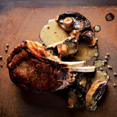 Thick-cut rib-eye with mushroom and green peppercorn sauce