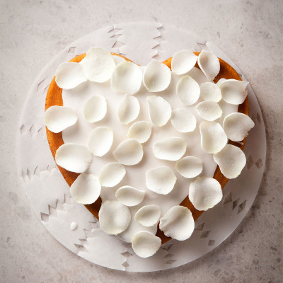 Coconut cake with rose-water icing and candied rose petals