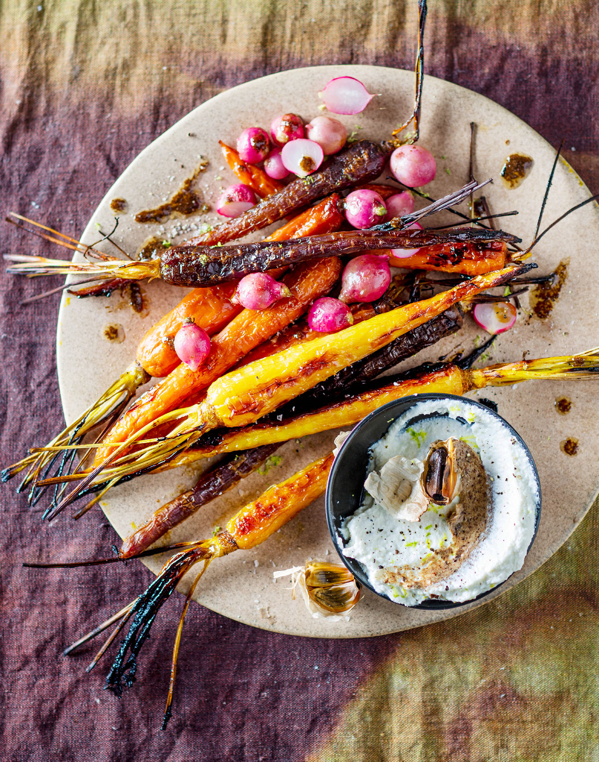 Roast black garlic with poached carrots and honey radishes