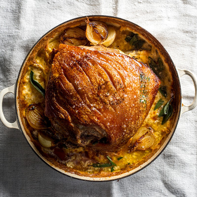 Pork shoulder braised in milk with baby onions