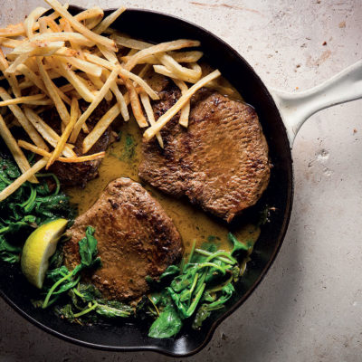 Steak with anchovy-spinach sauce and matchstick fries