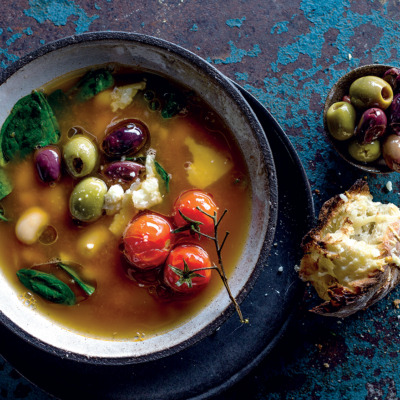 Tomato broth with baby spinach, cannellini beans and olives