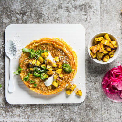 Omelette wraps filled with spicy coconut-fried potato