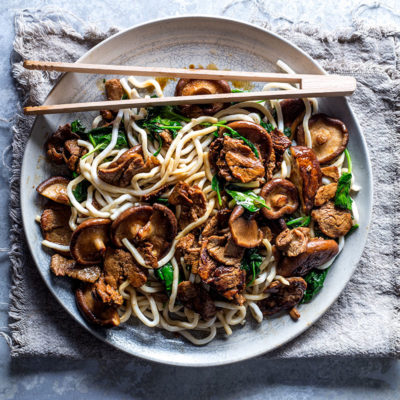 Teriyaki pork and mushrooms on spinach noodles