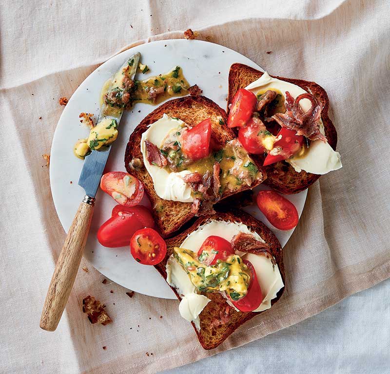 Anchovy on toast with fresh tomato and parsley butter