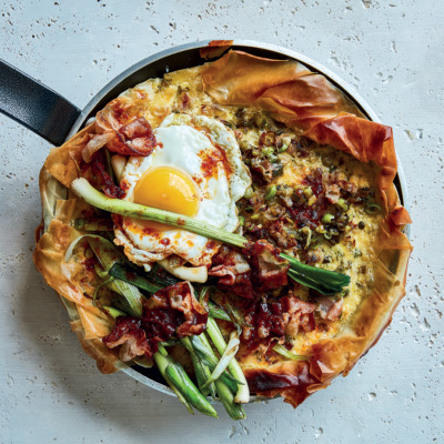 Leek-and-pancetta skillet breakfast tart with crispy harissa-fried eggs