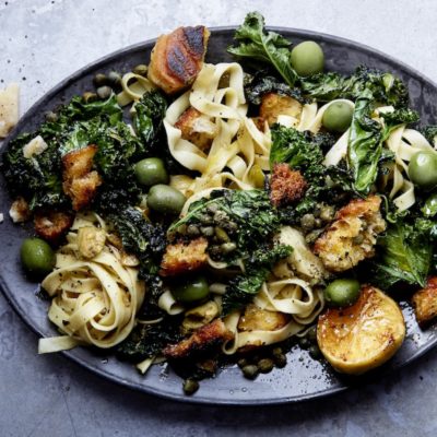 Home-made pasta with green olives, kale and chilli