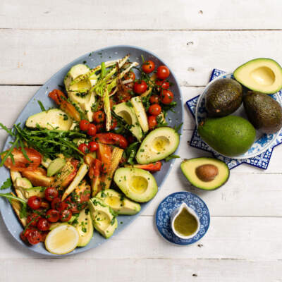 Avocado salad with roast tomatoes, baby corn, & spring onions