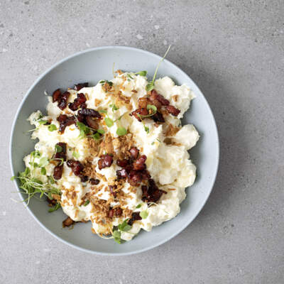 Potato salad with honey glazed bacon bits with crispy onions  