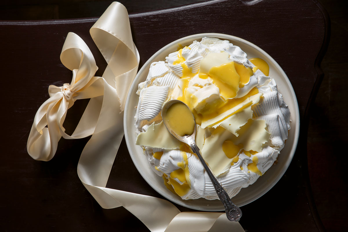 Pavlova with white chocolate shards and lemon, lime, grapefruit and ginger curd